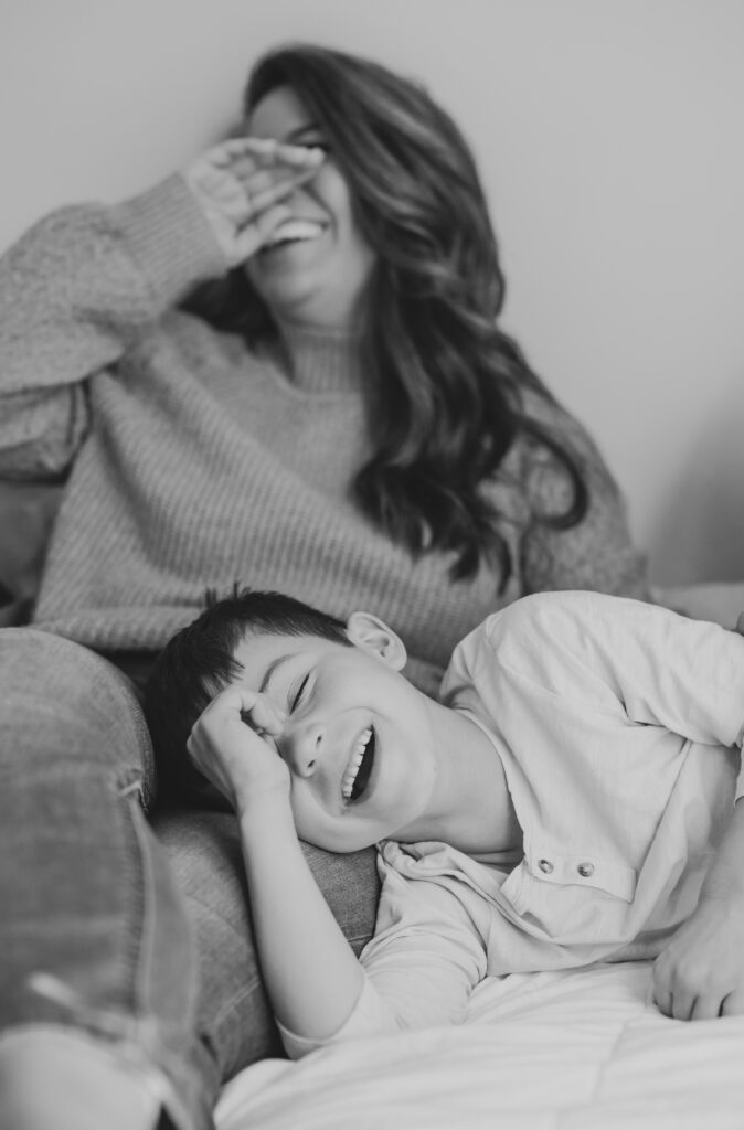 Victoria V laughing with her son during a family photoshoot