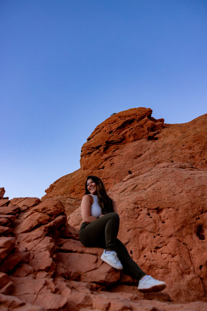Portrait of wedding photographer Victoria V at a mountain overlook during golden hour