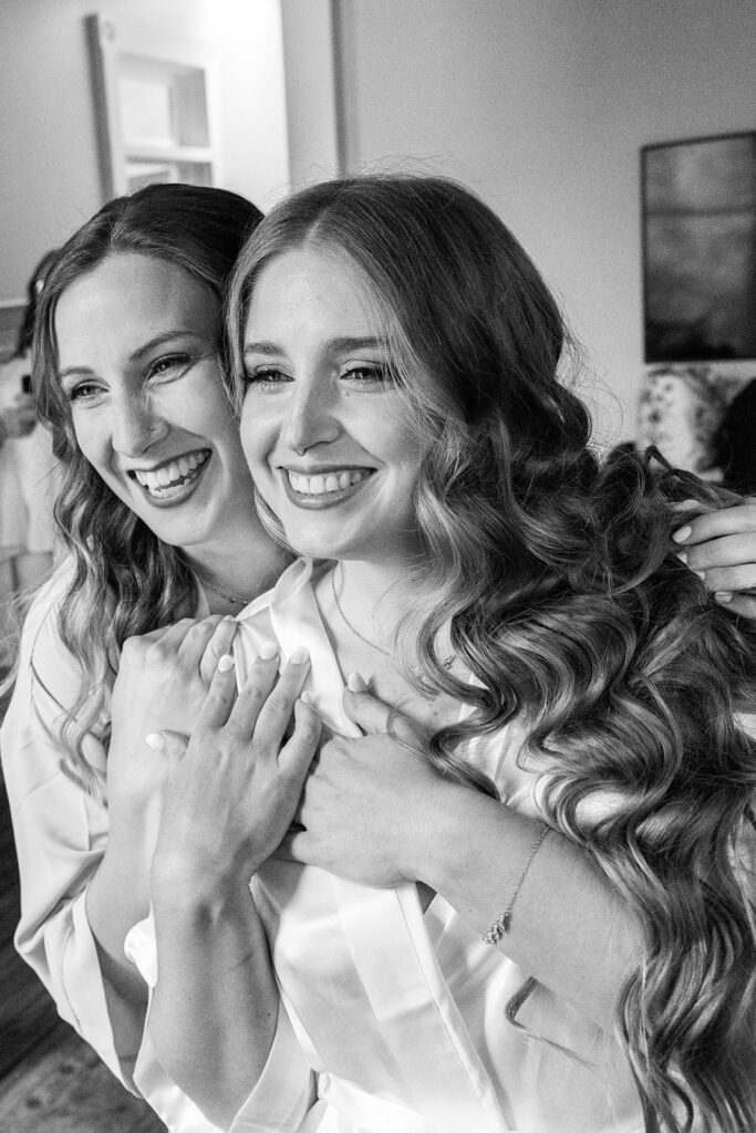 Bride laughing with bridesmaids during getting ready time for full wedding photography coverage