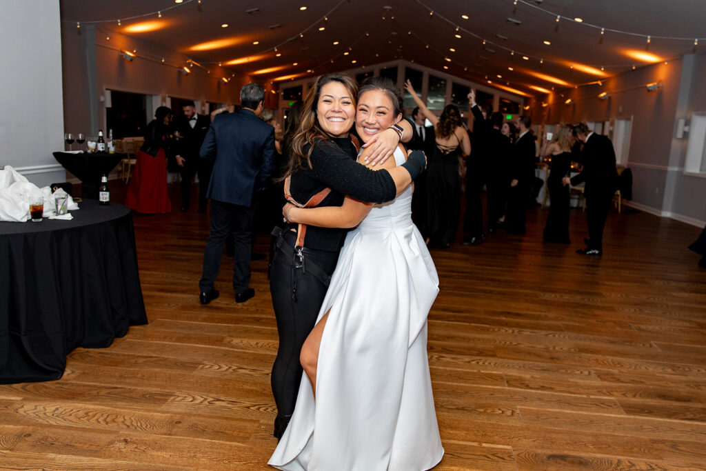 Bride with her wedding photographer, showing a strong connection on the big day