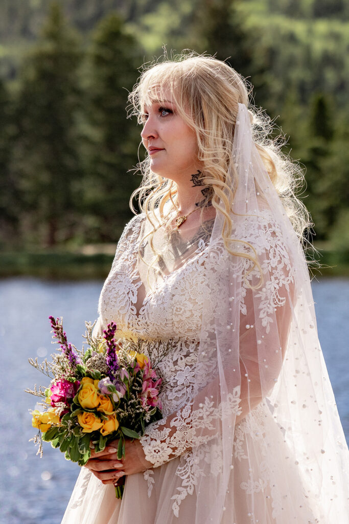 Professional photos by a Colorado elopement photographer of a Bride and groom during a Colorado elopement at Rocky Mountain National Park with elopement photography at Sprague Lake