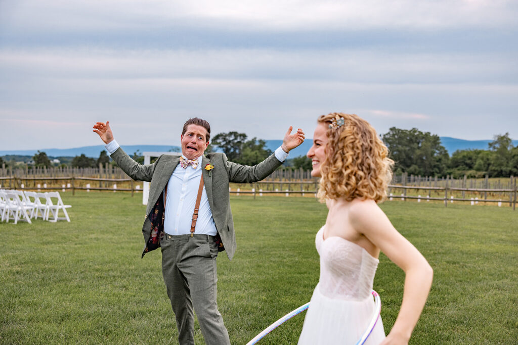 Bride and groom using hula hoops and enjoying their reception on their wedding day at a Shenandoah wedding venue Faithbrooke Farm and Vineyards