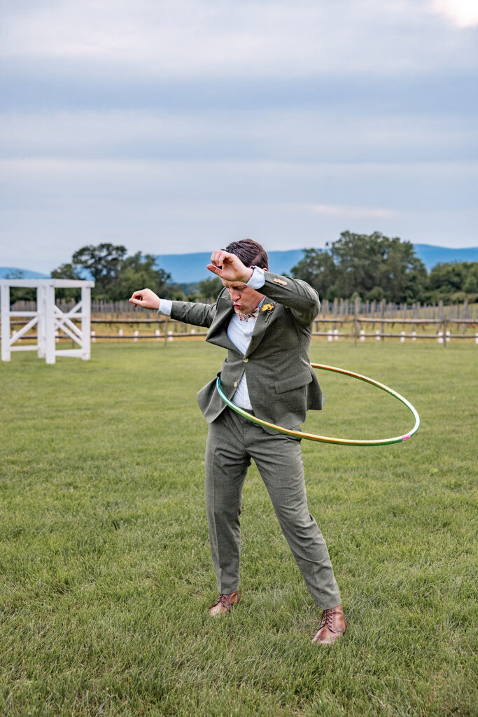 Bride and groom using hula hoops and enjoying their reception on their wedding day at a Shenandoah wedding venue Faithbrooke Farm and Vineyards