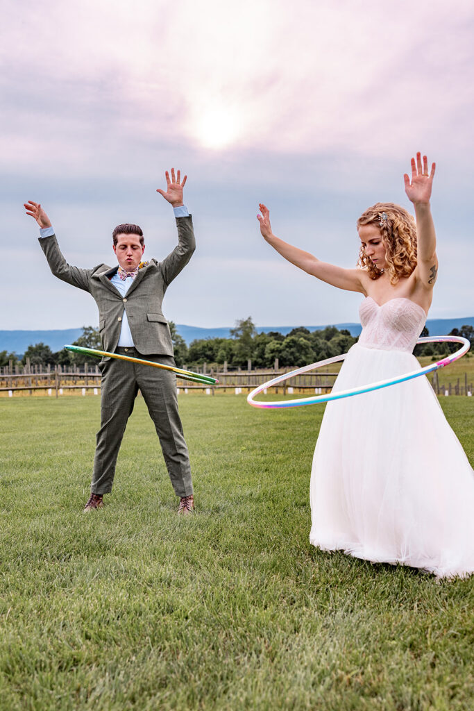 Bride and groom using hula hoops and enjoying their reception on their wedding day at a Shenandoah wedding venue Faithbrooke Farm and Vineyards