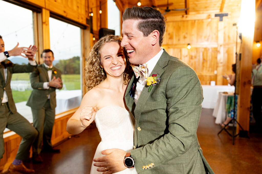 Bride and groom partying and enjoying their reception on their wedding day at a Shenandoah wedding venue Faithbrooke Farm and Vineyards for a spring wedding during their first dance