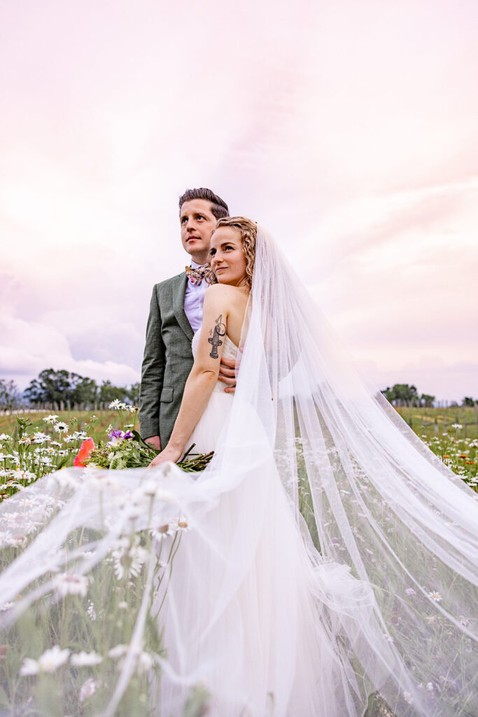 Bride and groom sunset portraits sunset photos on their wedding day at a Shenandoah wedding venue, faithbrooke farm and vineyards for a spring wedding in Shenandoah