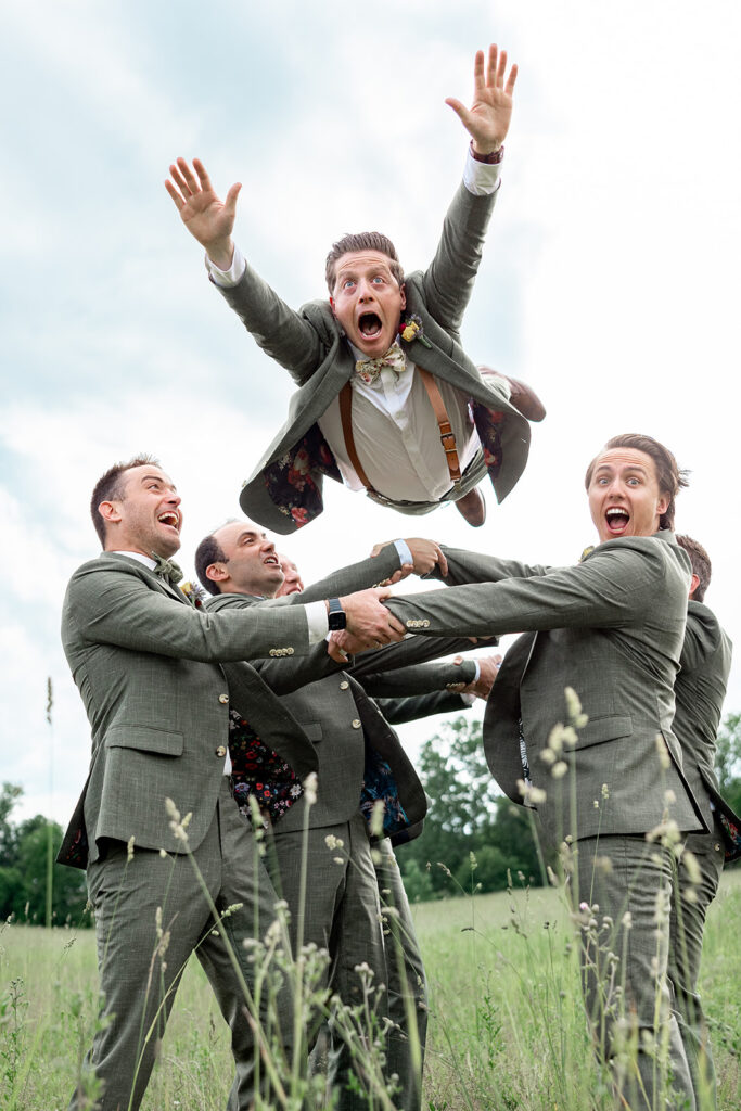 Bridal party portraits groomsman photos on their wedding day at a Shenandoah wedding venue, faithbrooke farm and vineyards for a spring wedding in Shenandoah