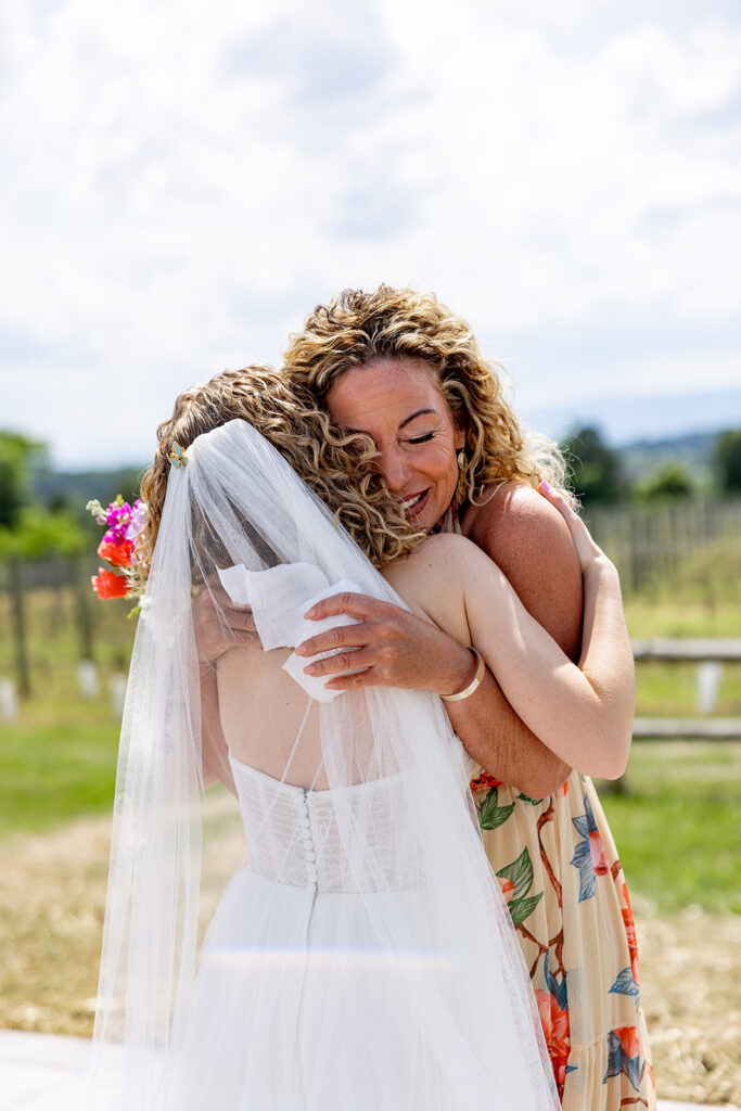 Mother and daughter embracing during a private exchange of gifts during a wedding at a Shenandoah Wedding Venue, Faithbrooke Farm and Vineyards