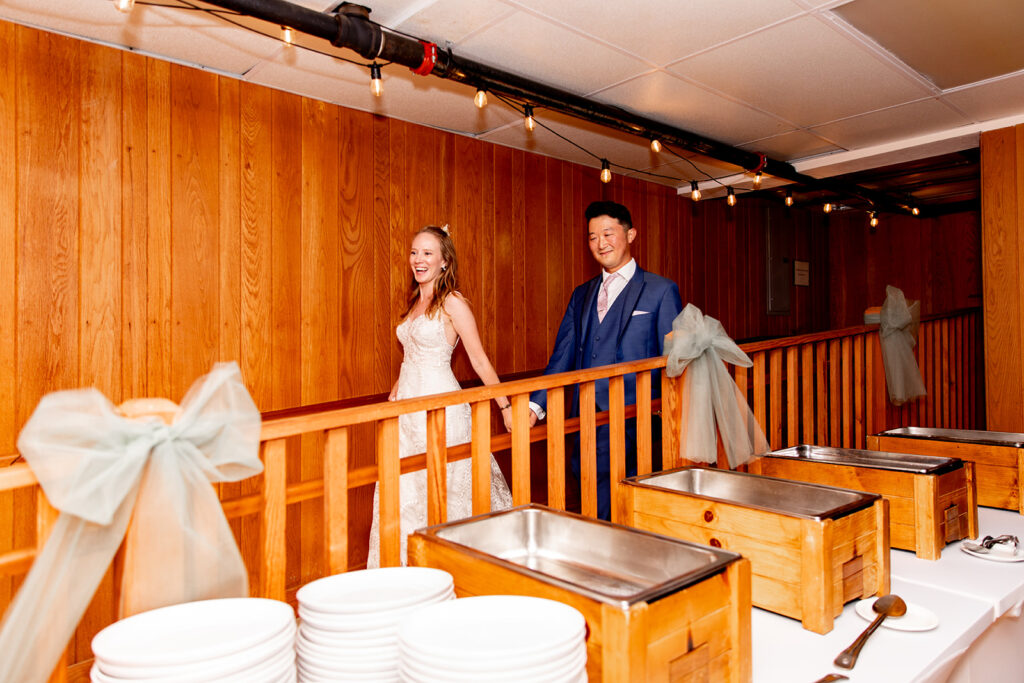 Bride and groom during a spring wedding entering their reception at a shenandoah wedding venue on their wedding day