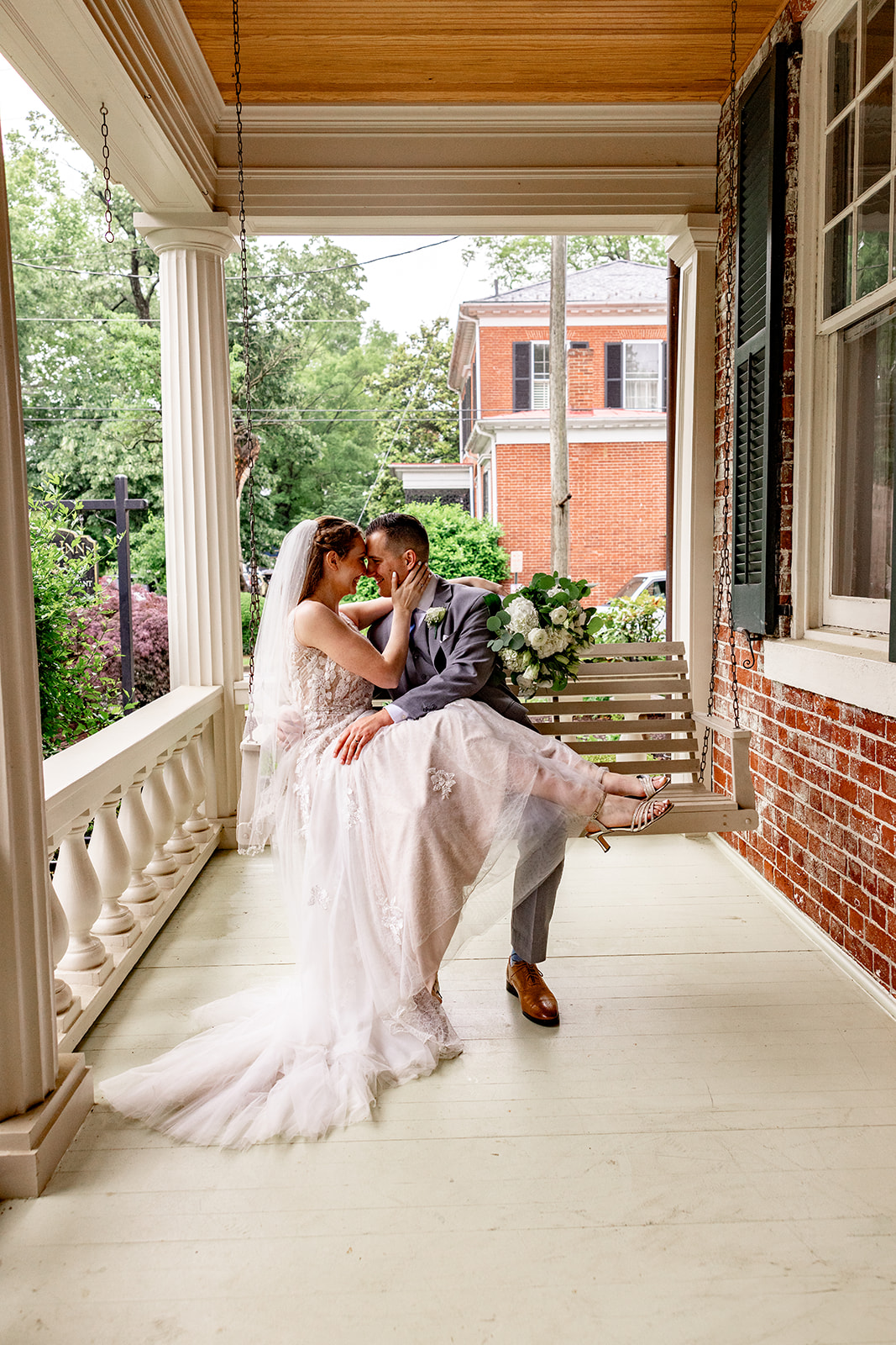 Romantic wedding portraits in downtown Fredericksburg, VA with a happy newlywed couple.