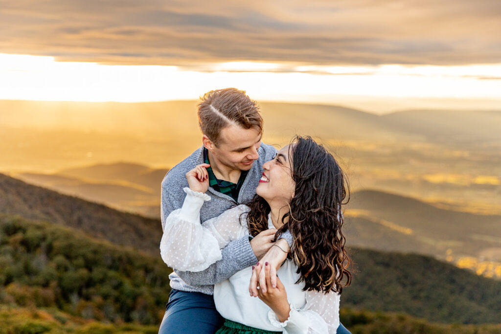 Bride and groom pose for engagement photos at golden hour in Shenandoah Valley with Victoria V Photography. Shenandoah wedding photographer. Shenandoah elopement photographer. Shenandoah sunset. Little Stony Man. Sunsets at Little Stony Man. Little Stony Man engagement session. Virginia elopement photographer.