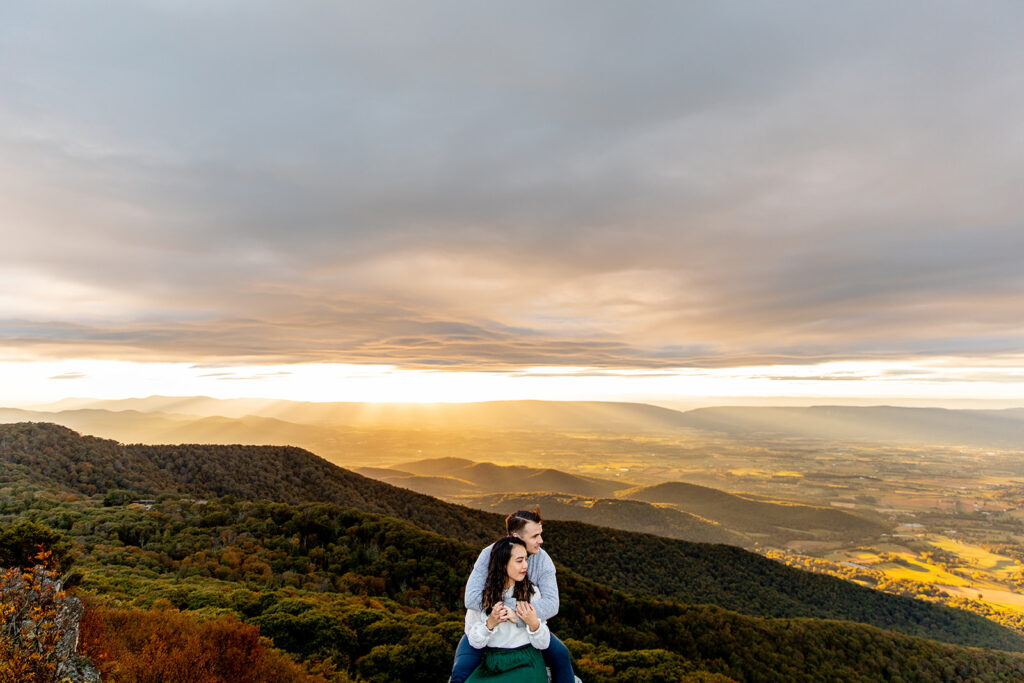 Bride and groom pose for engagement photos at golden hour in Shenandoah Valley with Victoria V Photography. Shenandoah wedding photographer. Shenandoah elopement photographer. Shenandoah sunset. Little Stony Man. Sunsets at Little Stony Man. Little Stony Man engagement session. Virginia elopement photographer.