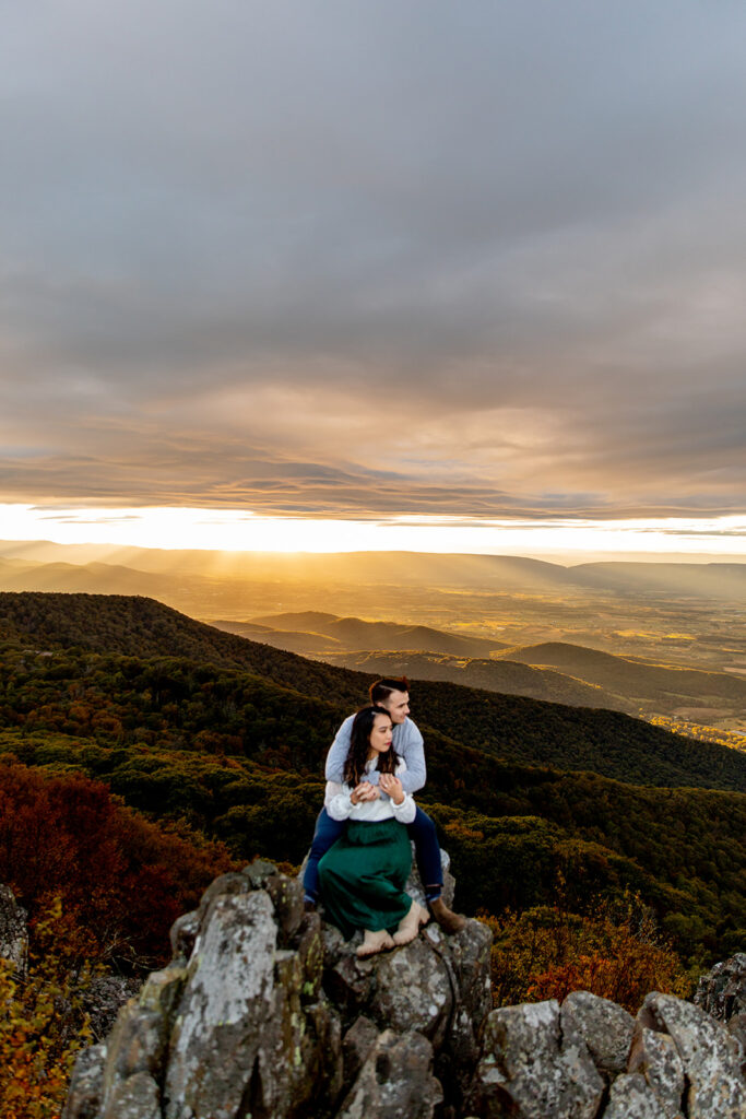 Bride and groom pose for engagement photos at golden hour in Shenandoah Valley with Victoria V Photography. Shenandoah wedding photographer. Shenandoah elopement photographer. Shenandoah sunset. Little Stony Man. Sunsets at Little Stony Man. Little Stony Man engagement session. Virginia elopement photographer.