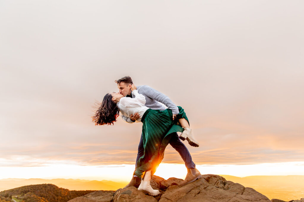 Bride and groom pose for engagement photos at golden hour in Shenandoah Valley with Victoria V Photography. Shenandoah wedding photographer. Shenandoah elopement photographer. Shenandoah sunset. Little Stony Man. Sunsets at Little Stony Man. Little Stony Man engagement session. Virginia elopement photographer.