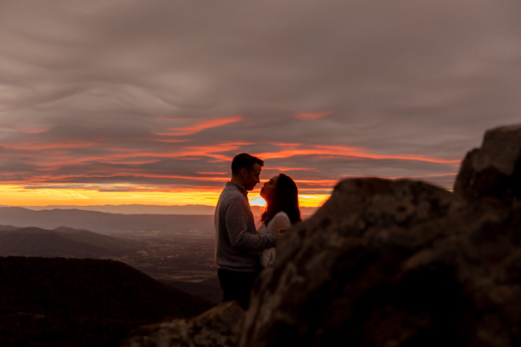 Bride and groom pose for engagement photos at golden hour in Shenandoah Valley with Victoria V Photography. Shenandoah wedding photographer. Shenandoah elopement photographer. Shenandoah sunset. Little Stony Man. Sunsets at Little Stony Man. Little Stony Man engagement session. Virginia elopement photographer.