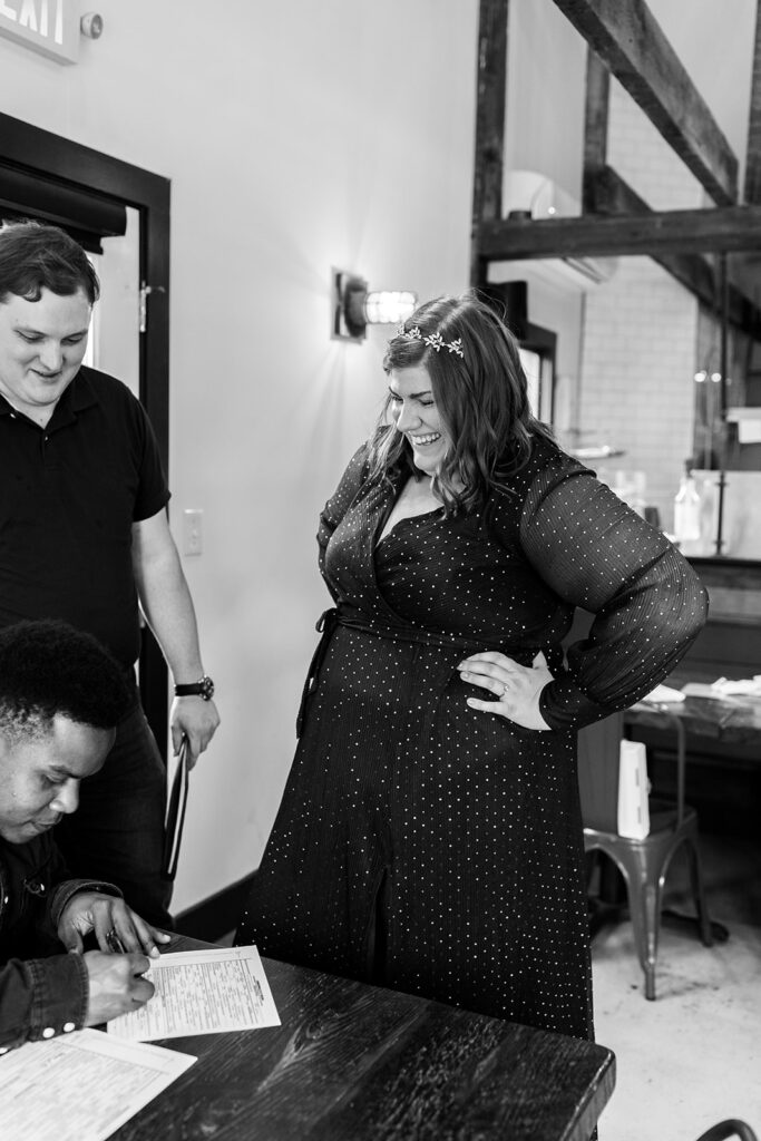 Bride and groom sign their marriage license before eloping in Shenandoah