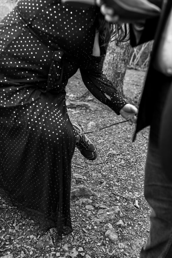 Bride changes out of her hiking shoes into wedding shoes for her wedding ceremony in Shenandoah