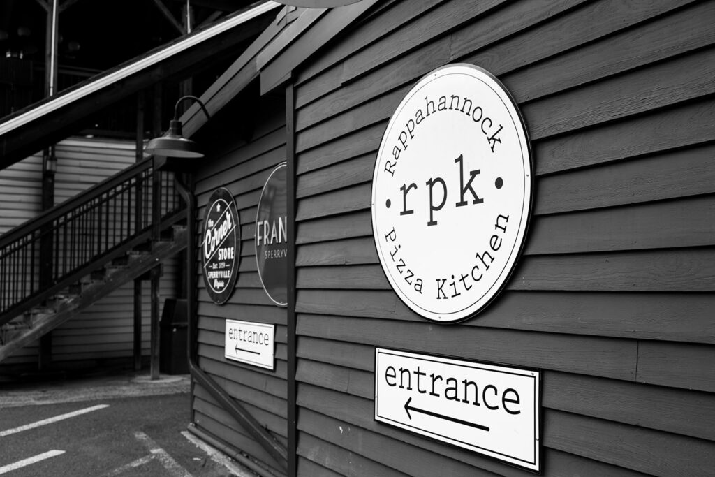 Rappahannock Pizza Kitchen sign outside of the pre-reception luncheon a bride and groom had for their Shenandoah elopement