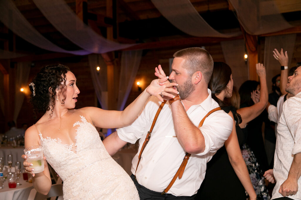 Elegant and adventurous mountain wedding at Stoneyman Valley Ranch – bride and groom portraits with Blue Ridge Mountain views, joyful first look, fun bridal party moments, and stunning sunset photos atop Little Stoneyman Overlook.