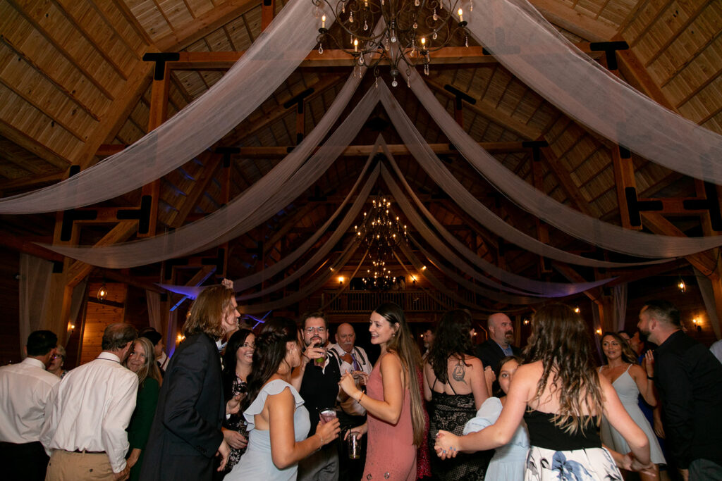 Elegant and adventurous mountain wedding at Stoneyman Valley Ranch – bride and groom portraits with Blue Ridge Mountain views, joyful first look, fun bridal party moments, and stunning sunset photos atop Little Stoneyman Overlook.