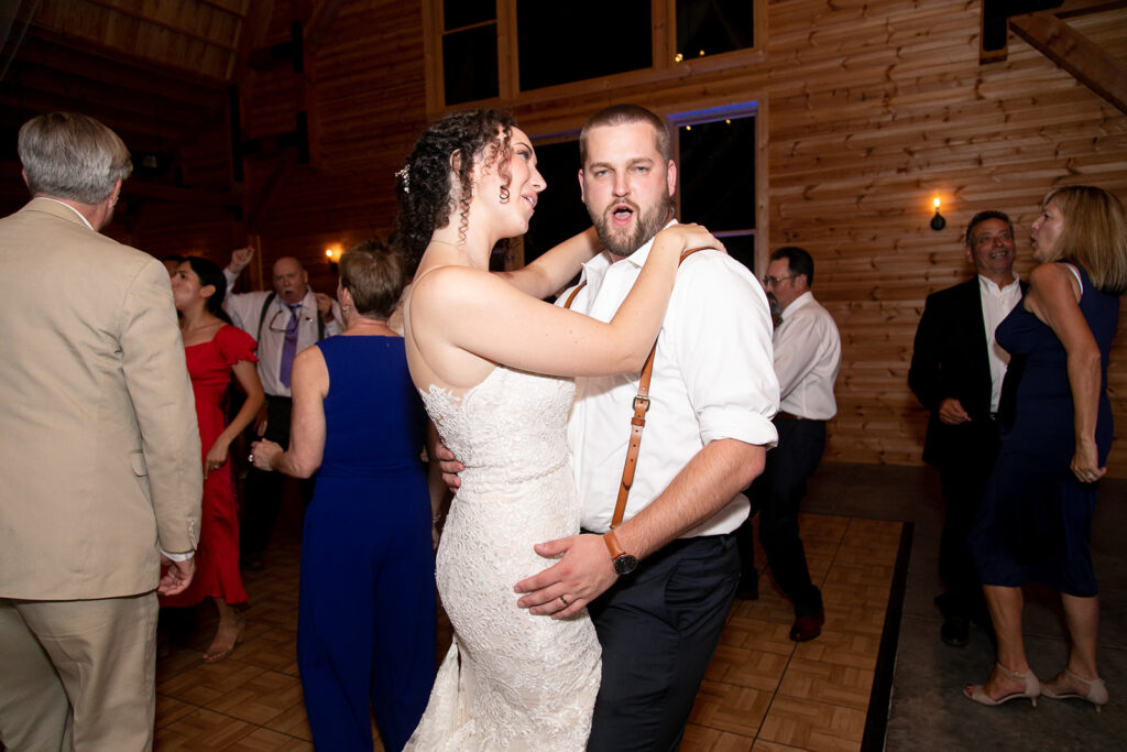 Elegant and adventurous mountain wedding at Stoneyman Valley Ranch – bride and groom portraits with Blue Ridge Mountain views, joyful first look, fun bridal party moments, and stunning sunset photos atop Little Stoneyman Overlook.