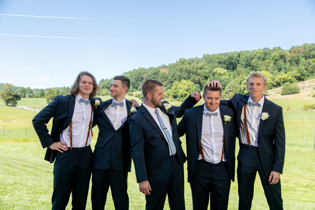 Elegant and adventurous mountain wedding at Stoneyman Valley Ranch – bride and groom portraits with Blue Ridge Mountain views, joyful first look, fun bridal party moments, and stunning sunset photos atop Little Stoneyman Overlook.