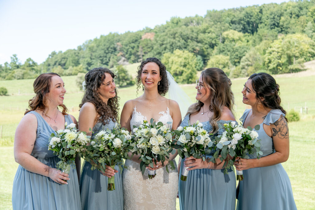 Elegant and adventurous mountain wedding at Stoneyman Valley Ranch – bride and groom portraits with Blue Ridge Mountain views, joyful first look, fun bridal party moments, and stunning sunset photos atop Little Stoneyman Overlook.