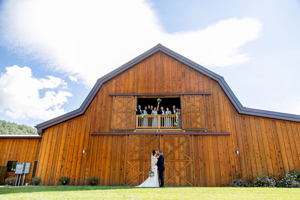 Elegant and adventurous mountain wedding at Stoneyman Valley Ranch – bride and groom portraits with Blue Ridge Mountain views, joyful first look, fun bridal party moments, and stunning sunset photos atop Little Stoneyman Overlook.