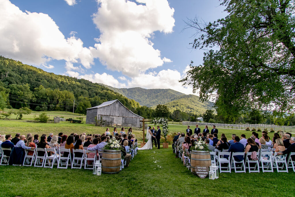 Elegant and adventurous mountain wedding at Stoneyman Valley Ranch – bride and groom portraits with Blue Ridge Mountain views, joyful first look, fun bridal party moments, and stunning sunset photos atop Little Stoneyman Overlook.