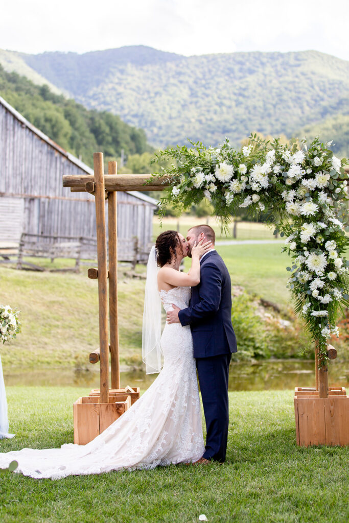 Elegant and adventurous mountain wedding at Stoneyman Valley Ranch – bride and groom portraits with Blue Ridge Mountain views, joyful first look, fun bridal party moments, and stunning sunset photos atop Little Stoneyman Overlook.