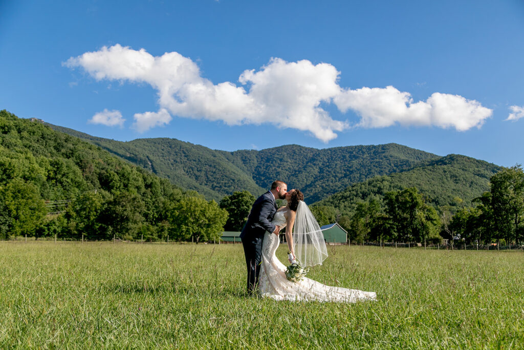 Elegant and adventurous mountain wedding at Stoneyman Valley Ranch – bride and groom portraits with Blue Ridge Mountain views, joyful first look, fun bridal party moments, and stunning sunset photos atop Little Stoneyman Overlook.