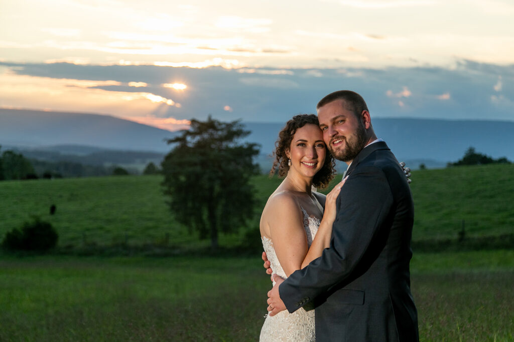 Elegant and adventurous mountain wedding at Stoneyman Valley Ranch – bride and groom portraits with Blue Ridge Mountain views, joyful first look, fun bridal party moments, and stunning sunset photos atop Little Stoneyman Overlook.