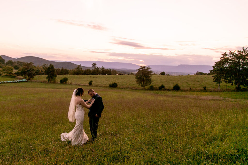 Elegant and adventurous mountain wedding at Stoneyman Valley Ranch – bride and groom portraits with Blue Ridge Mountain views, joyful first look, fun bridal party moments, and stunning sunset photos atop Little Stoneyman Overlook.