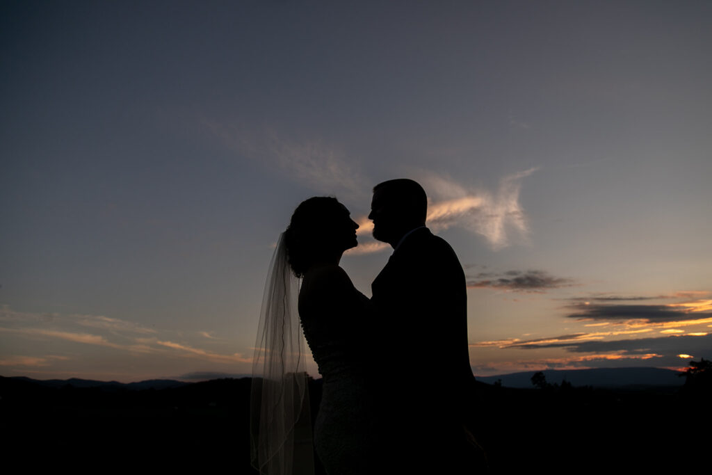 Elegant and adventurous mountain wedding at Stoneyman Valley Ranch – bride and groom portraits with Blue Ridge Mountain views, joyful first look, fun bridal party moments, and stunning sunset photos atop Little Stoneyman Overlook.