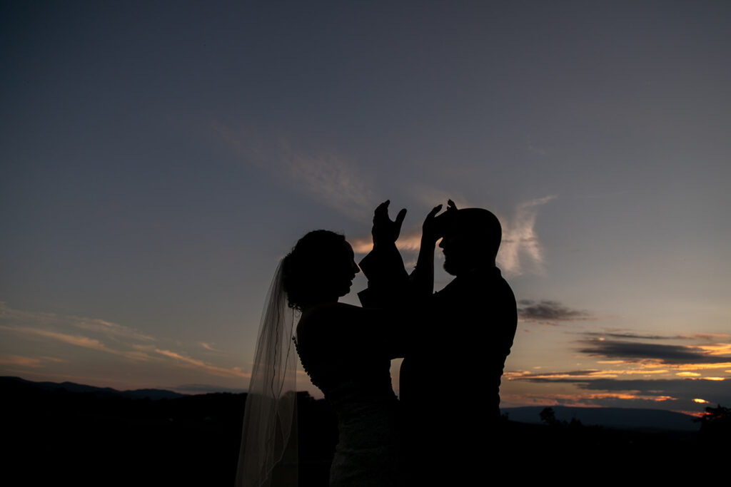 Elegant and adventurous mountain wedding at Stoneyman Valley Ranch – bride and groom portraits with Blue Ridge Mountain views, joyful first look, fun bridal party moments, and stunning sunset photos atop Little Stoneyman Overlook.