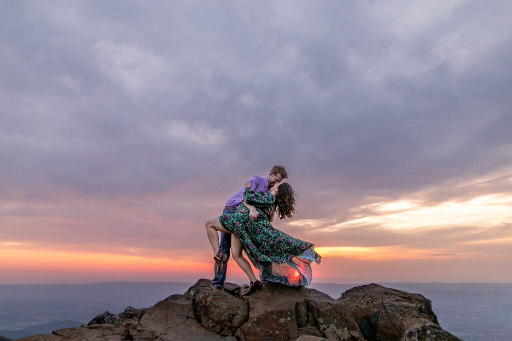 The bride’s gown billows in the mountain wind, adding an ethereal touch to this stunning Shenandoah engagement session.