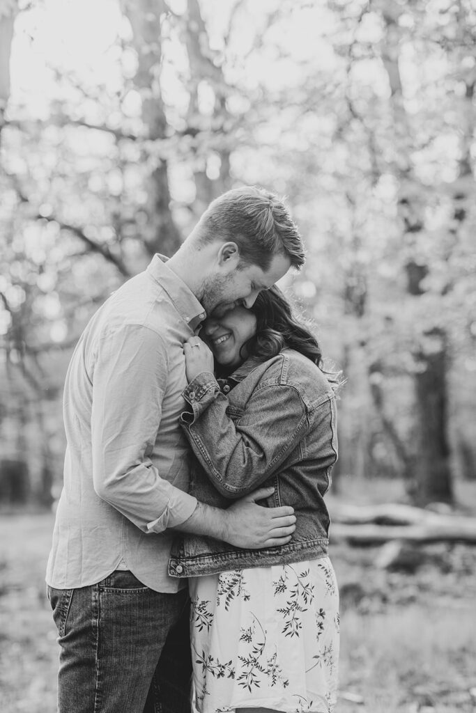 Couple snuggles close in their cozy, casual outfits for their Shenandoah engagement session.