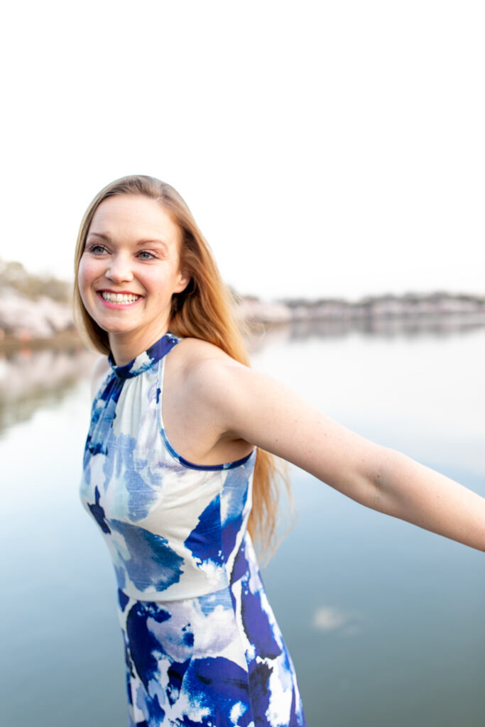 Sunrise engagement photo with Washington, DC’s cherry blossoms in a secluded location