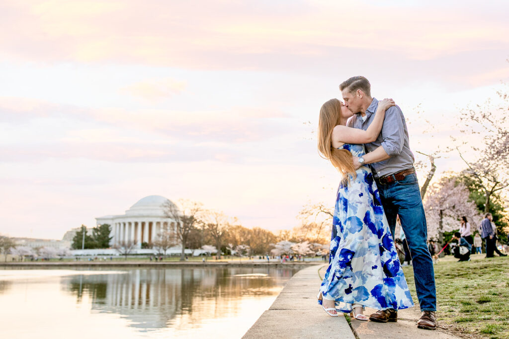 Spring sunrise engagement photoshoot at the Tidal Basin during the Cherry Blossom festival with the Jefferson Memorial in the background