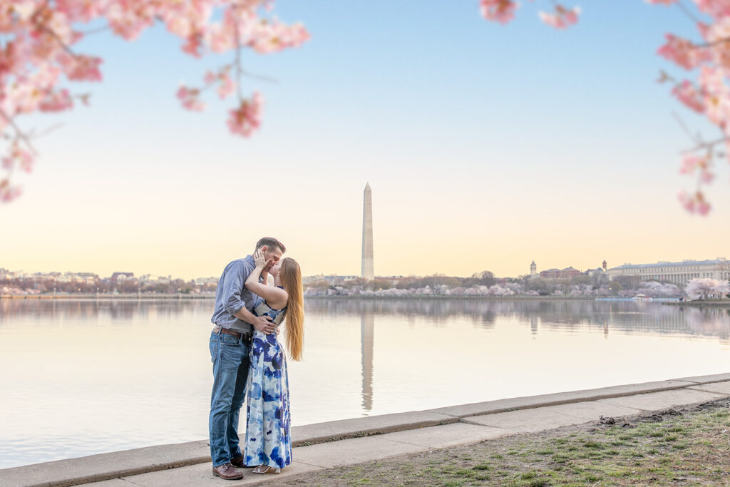 Cherry Blossom Festival engagement photo with soft pink blooms and a glowing sunrise in DC