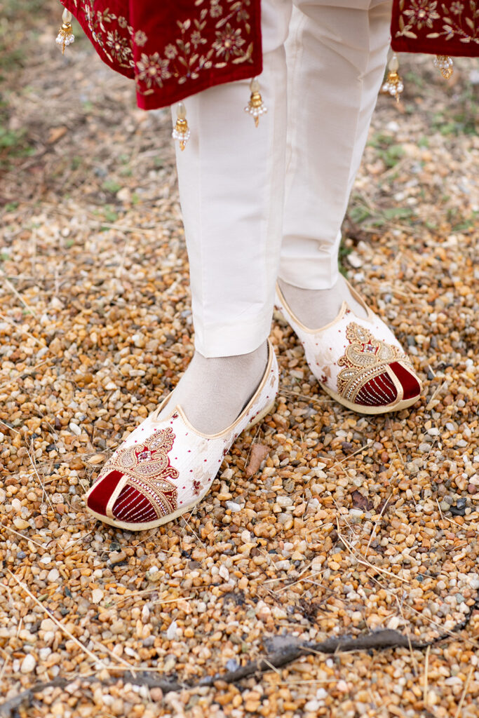 Close-up of groom’s traditional Indian wedding shoes (juttis) photographed as part of groom’s details at The Butterfly Field wedding