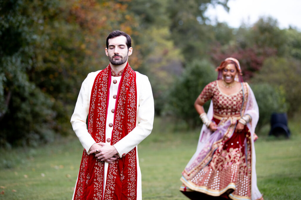 Emotional first look between bride and groom in the garden at The Butterfly Field wedding venue in Northern Virginia