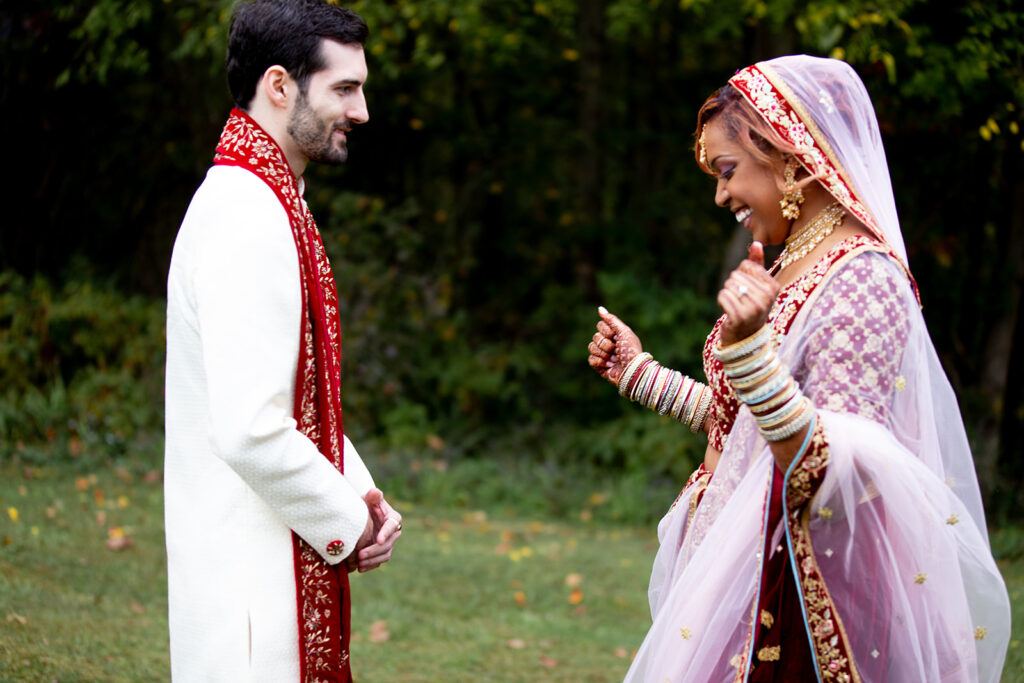Candid reaction as groom sees his bride for the first time during outdoor first look at Woodford, VA wedding