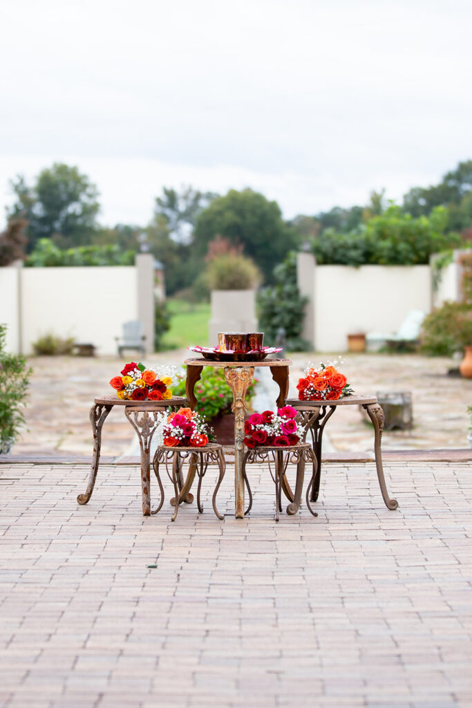 Outdoor Indian-American wedding ceremony setup at The Butterfly Field in Woodford, VA with floral decor and garden backdrop