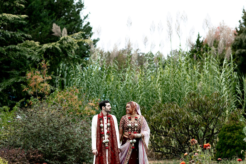 Bride and groom sharing a quiet moment in a wildflower-filled garden at their intimate Virginia wedding
