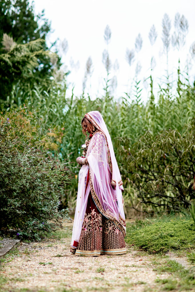 Natural and emotional bridal portrait of Saritha surrounded by wildflowers in Northern Virginia garden