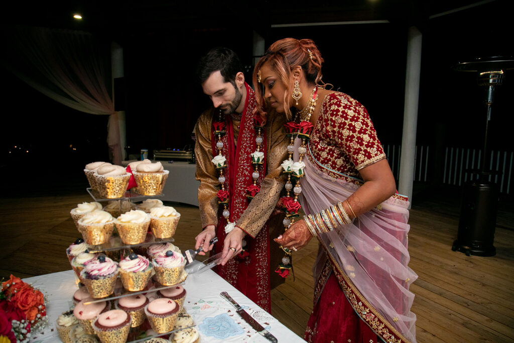 Couple cutting their wedding cake during joyful garden reception at Northern Virginia wedding venue