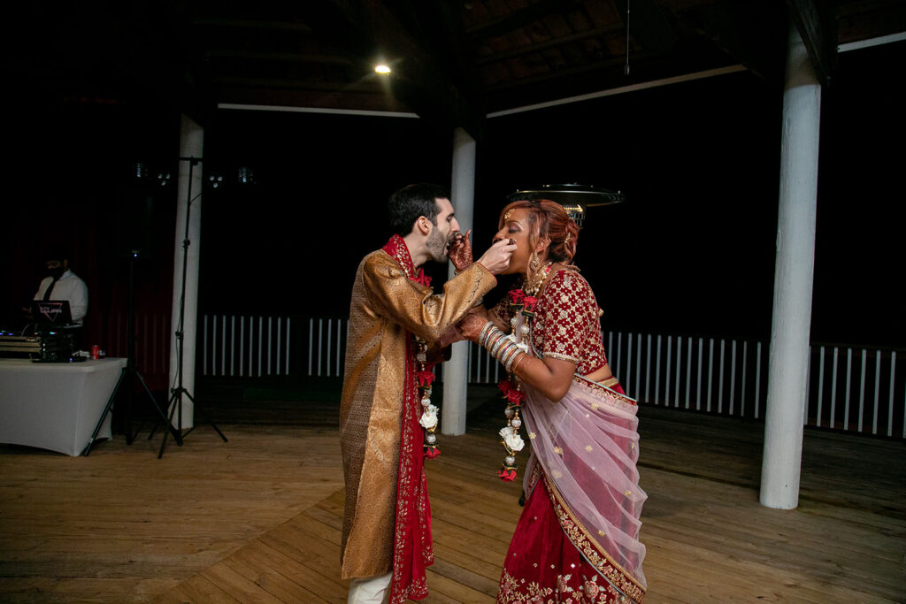 bride and groom feeding each other cake during their Northern Virginia wedding reception