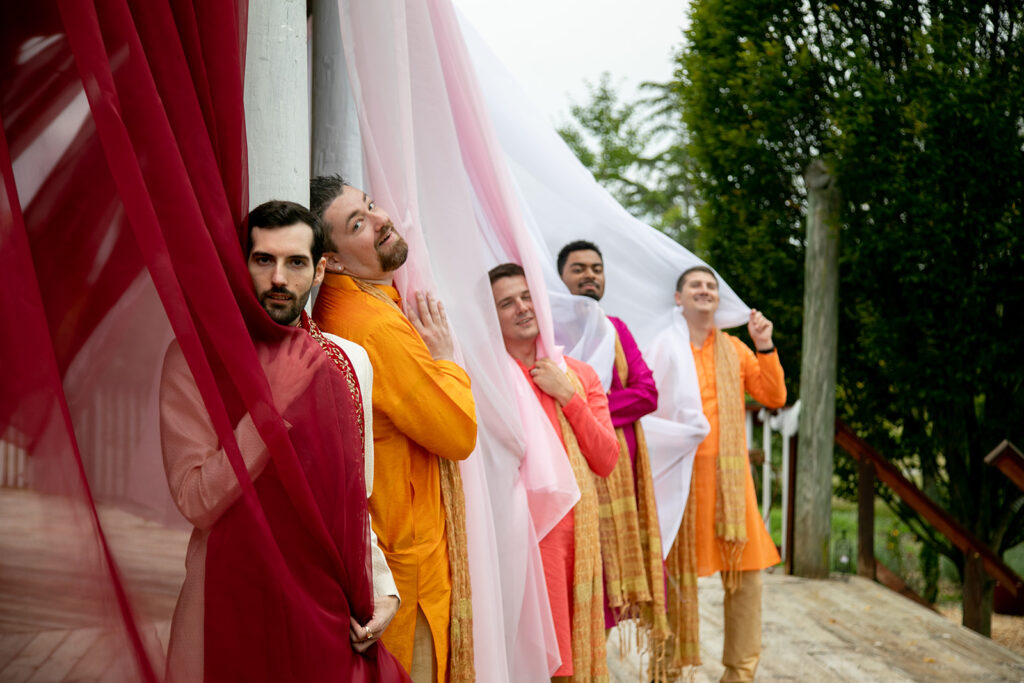 Groomsmen having fun in cultural wedding wear with the groom before ceremony at Northern Virginia garden venue