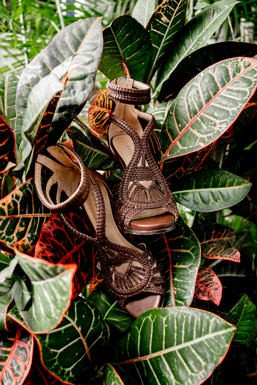 Bohemian wedding shoes styled with tropical foliage